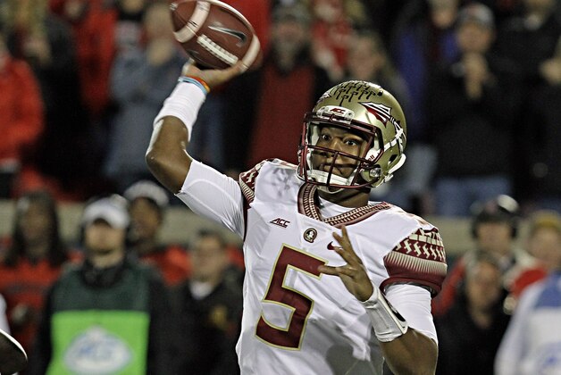 Florida State quarterback Jameis Winston (5) looks to pass in the first half of a NCAA college football game against Louisville in Louisville, Ky., Thursday, Oct. 30, 2014. (AP Photo/Garry Jones)