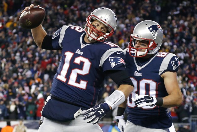 New England Patriots quarterback Tom Brady (12) celebrates with wide receiver Danny Amendola (80) in the first half of an NFL football game against the Denver Broncos on Sunday, Nov. 2, 2014, in Foxborough, Mass. (AP Photo/Elise Amendola)
