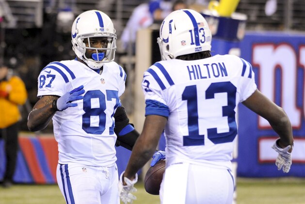 Indianapolis Colts wide receiver Reggie Wayne (87) and T.Y. Hilton (13) celebrate after a touchdown by Wayne during the second half of an NFL football game against the New York Giants Monday, Nov. 3, 2014, in East Rutherford, N.J.  (AP Photo/Bill Kostroun)