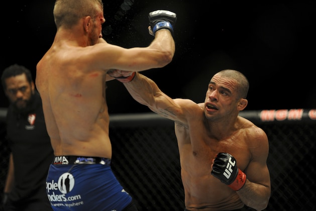 May 24, 2014; Las Vegas, NV, USA;  Renan Barao (red) throws a punch at TJ Dillashaw (blue) during their UFC 173 bantamweight championship bout at MGM Grand Garden Arena. Dillashaw won the bout by way of TKO. Mandatory Credit: Stephen R. Sylvanie-USA TODAY Sports
