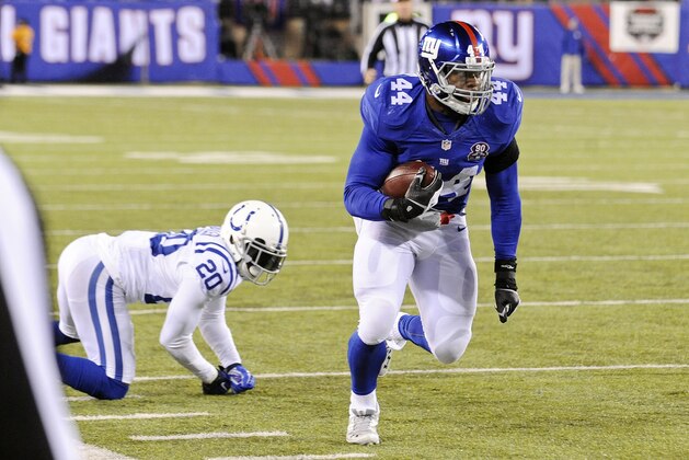 New York Giants running back Andre Williams (44) runs away from Indianapolis Colts' Darius Butler (20) for a touchdown during the second half of an NFL football game Monday, Nov. 3, 2014, in East Rutherford, N.J. (AP Photo/Bill Kostroun)