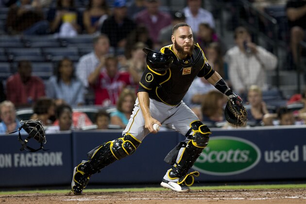 Pittsburgh Pirates catcher Russell Martin (55) prepares to throw out Atlanta Braves' Aaron Harang after a dropped third strike in the fourth inning of a baseball game  Monday, Sept. 22, 2014, in Atlanta. (AP Photo/John Bazemore)