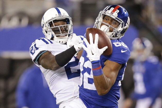 New York Giants tight end Larry Donnell (84) catches a pass in front of Indianapolis Colts' Vontae Davis (21) during the second half of an NFL football game Monday, Nov. 3, 2014, in East Rutherford, N.J.  (AP Photo/Kathy Willens)