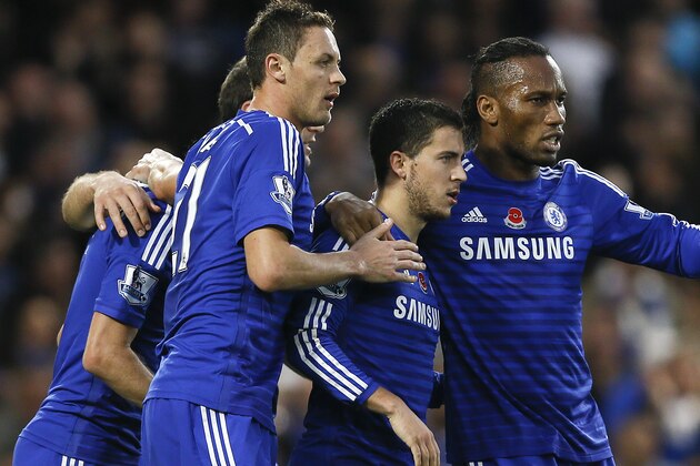 Chelsea's Eden Hazard, second right, celebrates with teammates after scoring a goal  during the English Premier League soccer match between Chelsea and Queens Park Rangers at Stamford Bridge Stadium in London, Saturday, Nov. 1, 2014. (AP Photo/Kirsty Wigglesworth)