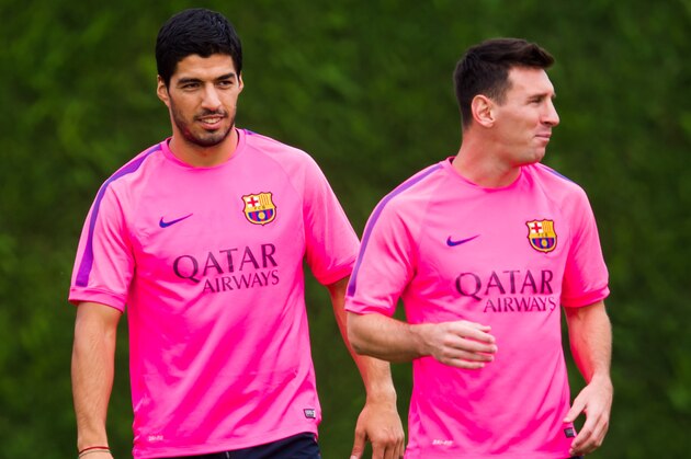 BARCELONA, SPAIN - AUGUST 17: Luis Suarez (L) and Lionel Messi (R) look on during a FC Barcelona training session at Ciutat Esportiva on August 17, 2014 in Barcelona, Spain.  (Photo by Alex Caparros/Getty Images)