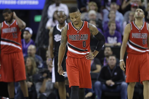 Portland Trail Blazers guard Damian Lillard walks down court after a being called for a foul during the closing moments of the Trail Blazers 103-94 loss to the Sacramento Kings in a  NBA basketball game in Sacramento, Calif. Friday, Oct. 31, 2014.(AP Photo/Rich Pedroncelli)