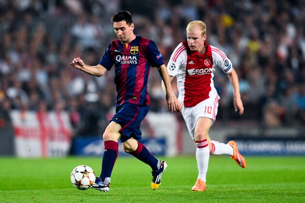 BARCELONA, SPAIN - OCTOBER 21:  Lionel Messi of FC Barcelona competes for the ball with Davy Klaassen of AFC Ajax Amsterdam during a UEFA Champions League Group F match between FC Barcelona and AFC Ajax at the Camp Nou Stadium on October 21, 2014 in Barcelona, Spain.  (Photo by David Ramos/Getty Images)