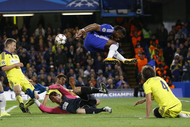10ThingstoSeeSports - Chelsea's Didier Drogba, top, leaps over Maribor's goalkeeper Jasmin Handanovic, second left, during the Champions League Group G soccer match between Chelsea and NK Maribor at Stamford Bridge stadium in London Tuesday, Oct. 21, 2014. (AP Photo/Kirsty Wigglesworth, File)