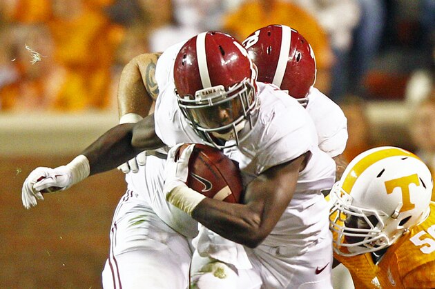 Alabama running back T.J. Yeldon (4) runs for yardage in the first quarter of an NCAA college football game against Tennessee Saturday, Oct. 25, 2014 in Knoxville, Tenn. (AP Photo/Wade Payne)
