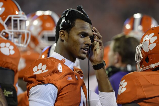 Clemson quarterback Deshaun Watson talks on the radio during the first half an NCAA college football game against Syracuse in Clemson, S.C.,  Saturday, Oct. 25, 2014. Clemson won 16-6. Watson is still recovering from a hand injury.  (AP Photo/ Richard Shiro)