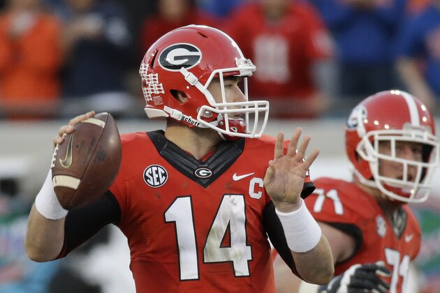Georgia quarterback Hutson Mason (14) throws a pass during the second half of an NCAA college football game against Florida  in Jacksonville, Fla., Saturday, Nov. 1, 2014. Florida won 38-20. (AP Photo/John Raoux)