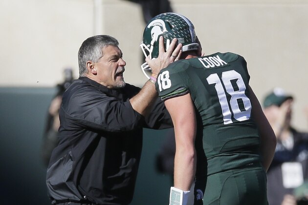 Ken Mannie, Michigan State strength and conditioning coach talks with quarterback Connor Cook (18) during the first half of an NCAA college football game against Michigan in East Lansing, Mich., Saturday, Oct. 25, 2014. (AP Photo/Carlos Osorio)
