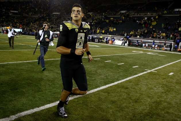 Oregon quarterback Marcus Mariota (8) runs off the field after an NCAA college football game against Stanford in Eugene, Ore., Saturday, Nov. 1, 2014. (AP Photo/Ryan Kang)