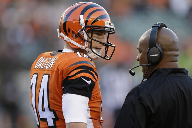 Cincinnati Bengals quarterback Andy Dalton talks with offensive coordinator Hue Jackson during the second half of an NFL football game against the Jacksonville Jaguars in Cincinnati, Sunday, Nov. 2, 2014. (AP Photo/David Kohl)