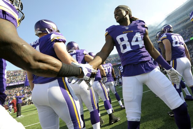 Minnesota Vikings wide receiver Cordarrelle Patterson (84) shakes hands with teammates during introductions  before the first half of an NFL football game against the Washington Redskins, Sunday, Nov. 2, 2014, in Minneapolis. (AP Photo/Jim Mone)