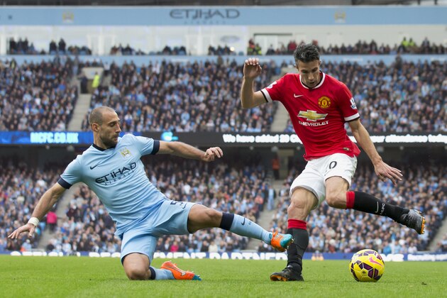 Manchester City's Pablo Zabaleta, left, fights for the ball against Manchester United's Robin van Persie during their English Premier League soccer match at the Etihad Stadium, Manchester, England, Sunday Nov. 2, 2014. (AP Photo/Jon Super)