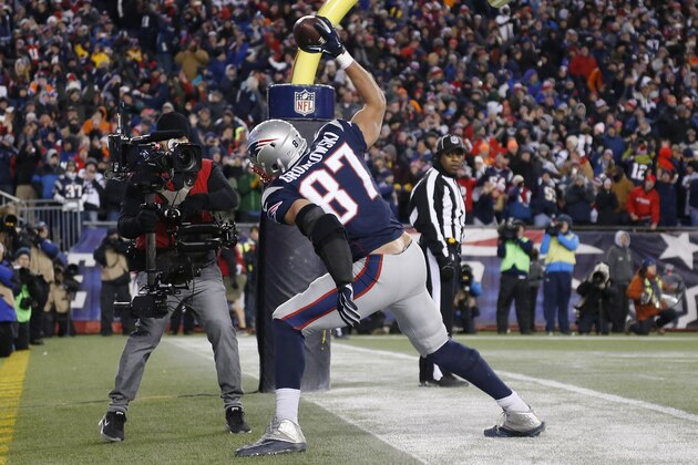 New England Patriots tight end Rob Gronkowski celebrates in the end zone after catching a touchdown pass from quarterback Tom Brady in the second half of an NFL football game against the Denver Broncos on Sunday, Nov. 2, 2014, in Foxborough, Mass. (AP Photo/Elise Amendola)