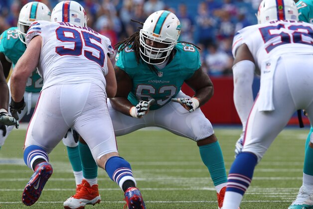Sep 14, 2014; Orchard Park, NY, USA; Miami Dolphins guard Dallas Thomas (63) looks to block Buffalo Bills defensive tackle Kyle Williams (95) at Ralph Wilson Stadium. Buffalo beats Miami 29 to 10.  Mandatory Credit: Timothy T. Ludwig-USA TODAY Sports