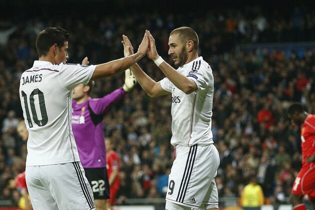Real Madrid's Karim Benzema, centre, celebrates with James Rodriguez after scoring the opening goal during a Group B Champions League soccer match between Real Madrid and Liverpool at the Santiago Bernabeu stadium in Madrid, Spain, Tuesday Nov. 4, 2014. (AP Photo/Andres Kudacki)
