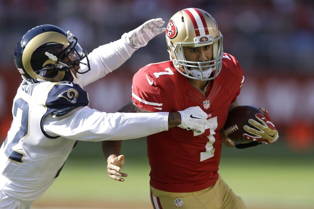 San Francisco 49ers quarterback Colin Kaepernick (7) runs from the grasp of St. Louis Rams cornerback Trumaine Johnson during the second quarter of an NFL football game in Santa Clara, Calif., Sunday, Nov. 2, 2014. (AP Photo/Ben Margot)