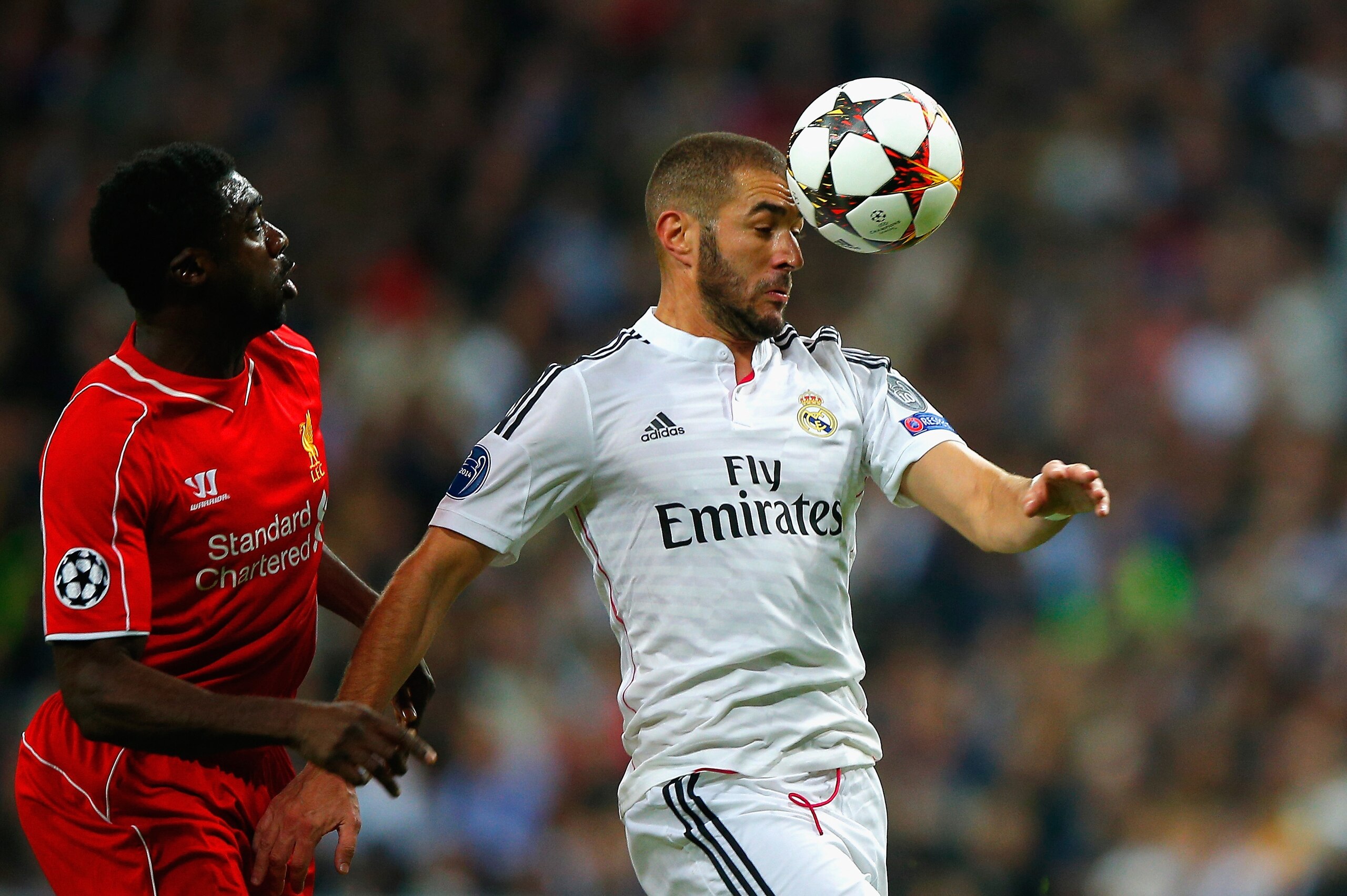 MADRID, SPAIN - NOVEMBER 04:  Karim Benzema of Real Madrid CF heads the ball under pressure from Kolo Toure of Liverpool during the UEFA Champions League Group B match between Real Madrid CF and Liverpool FC at Estadio Santiago Bernabeu on November 4, 2014 in Madrid, Spain.  (Photo by Gonzalo Arroyo Moreno/Getty Images)