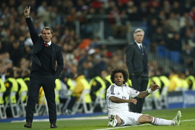 Liverpool's head coach Brendan Rodgers gestures as Real Madrid's Marcelo sits on the pitch during a Group B Champions League soccer match between Real Madrid and Liverpool at the Santiago Bernabeu stadium in Madrid, Spain, Tuesday Nov. 4, 2014. (AP Photo/Andres Kudacki)