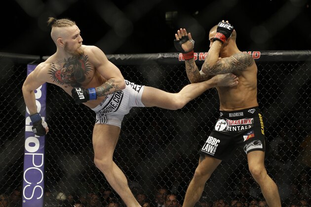 Connor McGregor kicks Dustin Poirier in their featherweight mixed martial arts bout at UFC 178 on Saturday, Sept. 27, 2014, in Las Vegas. (AP Photo/John Locher)