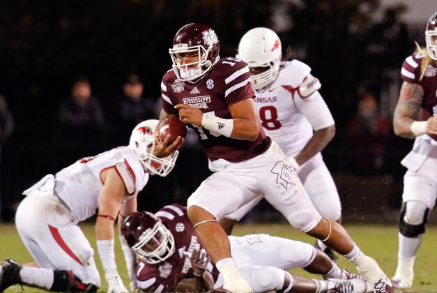 Nov 1, 2014; Starkville, MS, USA; Mississippi State Bulldogs quarterback Dak Prescott (15) carries the ball against the Arkansas Razorbacks at Davis Wade Stadium.  The Bulldogs defeat the Razorbacks 17-10. Mandatory Credit: Marvin Gentry-USA TODAY Sports