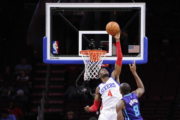 Philadelphia 76ers' Nerlens Noel (4) blocks a shot from Charlotte Hornets' Bismack Biyombo (8) during a preseason NBA basketball game against the Charlotte Hornets in Philadelphia, Wednesday, Oct. 8, 2014. (AP Photo/Michael Perez)