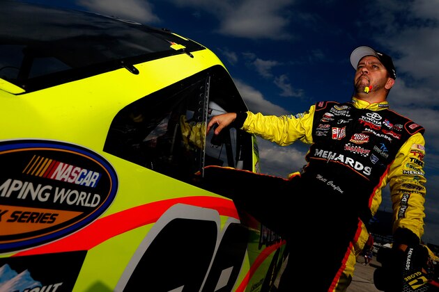 FORT WORTH, TX - OCTOBER 30:  Matt Crafton, driver of the #88 Goof Off/Menards Toyota, climbs from his truck following practice for the NASCAR Camping World Truck Series WinStar World Casino & Resort 350 at Texas Motor Speedway on October 30, 2014 in Fort Worth, Texas.  (Photo by Sean Gardner/Getty Images for Texas Motor Speedway)