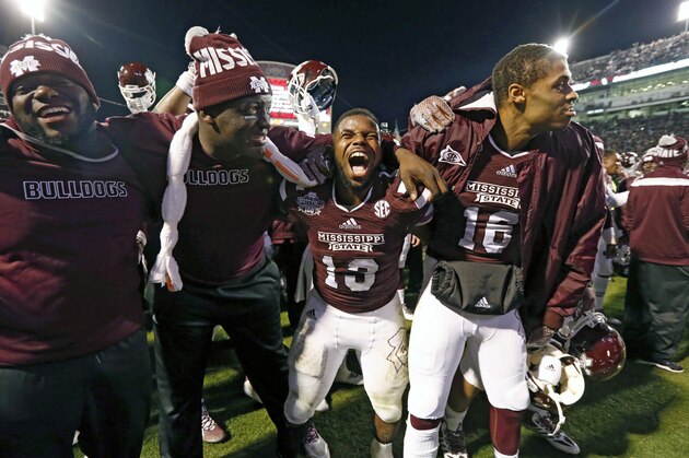 Mississippi State running back Josh Robinson (13) and some teammates celebrate their victory over Arkansas in their NCAA college football game in Starkville, Miss., Saturday, Nov. 1, 2014. No. 1 Mississippi State won 17-10. (AP Photo/Rogelio V. Solis)