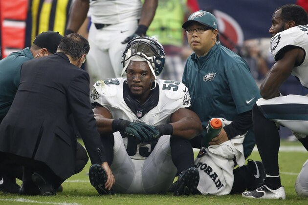 Philadelphia Eagles inside linebacker DeMeco Ryans (59) is tended to by team personnel after being injured during the fourth quarter of an NFL football game, Sunday, Nov. 2, 2014, in Houston. (AP Photo/Tony Gutierrez)