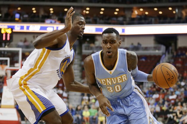 Denver Nuggets forward Quincy Miller, right, drives past Golden State Warriors forward Harrison Barnes during the second half of a preseason NBA basketball game, Thursday, Oct. 16, 2014, in Des Moines, Iowa. Golden State won 104-101. (AP Photo/Charlie Neibergall)