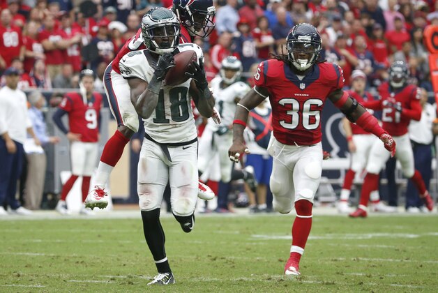 Philadelphia Eagles wide receiver Jeremy Maclin, front, catches a 52-yard pass as Houston Texans defensive back Andre Hal  and strong safety D.J. Swearinger, right, defend during the second quarter of an NFL football game, Sunday, Nov. 2, 2014, in Houston. (AP Photo/Tony Gutierrez)