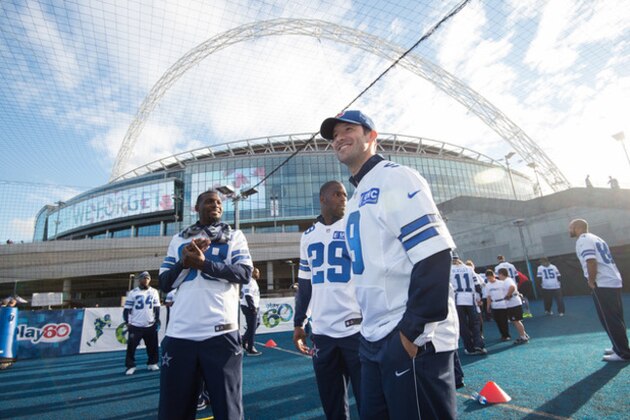 Dallas Cowboys quarterback Tony Romo, right, looks stands with running back DeMarco Murray, center, and wide receiver Dez Bryant, left, during a community day event outside Wembley Stadium in London, England, Tuesday Nov. 4, 2014. The Dallas Cowboys will play the Jacksonville Jaguars in an NFL football game at Wembley Stadium on Sunday Nov. 9 (AP Photo/Tim Ireland)