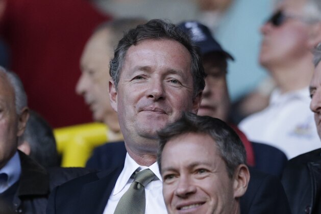 Noted Arsenal fan and CNN talk show host Piers Morgan in the crowd as he wait to watch the English Premier League soccer match between Tottenham Hotspur and Arsenal at White Hart Lane stadium in London, Sunday, March 16, 2014. (AP Photo/Matt Dunham)