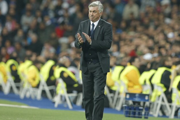 Real Madrid's coach Carlo Ancelotti applauds his team from the sidelines during a Group B Champions League soccer match between Real Madrid and Liverpool at the Santiago Bernabeu stadium in Madrid, Spain, Tuesday Nov. 4, 2014. (AP Photo/Paul White)