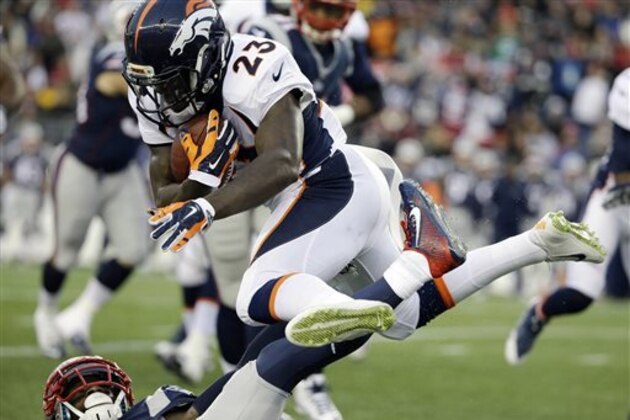 Denver Broncos running back Ronnie Hillman (23) leaps over a New England Patriots defender in the first half of an NFL football game on Sunday, Nov. 2, 2014, in Foxborough, Mass. (AP Photo/Steven Senne)