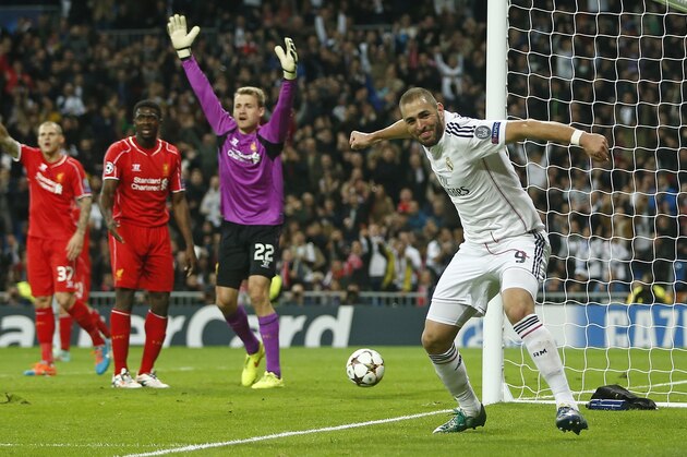 Real Madrid's Karim Benzema, right, celebrates after scoring the opening goal during a Group B Champions League soccer match between Real Madrid and Liverpool at the Santiago Bernabeu stadium in Madrid, Spain, Tuesday Nov. 4, 2014. (AP Photo/Andres Kudacki)