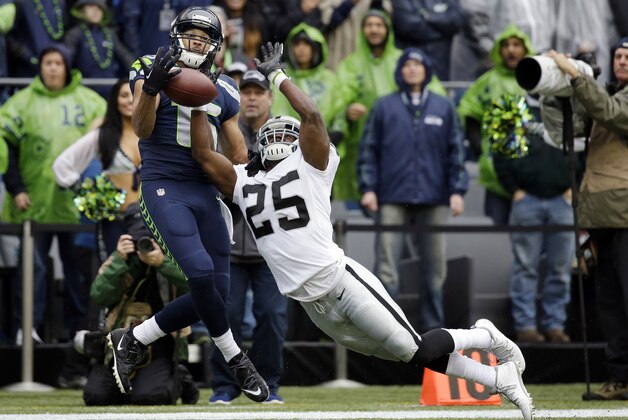 Oakland Raiders' D.J. Hayden (25) breaks up a pass to Seattle Seahawks' Jermaine Kearse, but was called for pass interference on the play in the first half of an NFL football game, Sunday, Nov. 2, 2014, in Seattle. (AP Photo/Elaine Thompson)