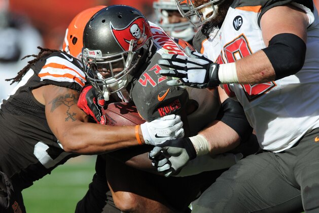 Nov 2, 2014; Cleveland, OH, USA; Tampa Bay Buccaneers running back Bobby Rainey (43) runs the ball as Cleveland Browns inside linebacker Karlos Dansby (56) tackles him during the second quarter at FirstEnergy Stadium. The Browns beat the Buccaneers 22-17. Mandatory Credit: Ken Blaze-USA TODAY Sports