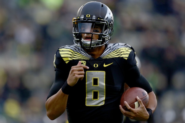 Oregon quarterback Marcus Mariota (8) runs the ball before an NCAA college football game against Stanford in Eugene, Ore., Saturday, Nov. 1, 2014. (AP Photo/Ryan Kang)