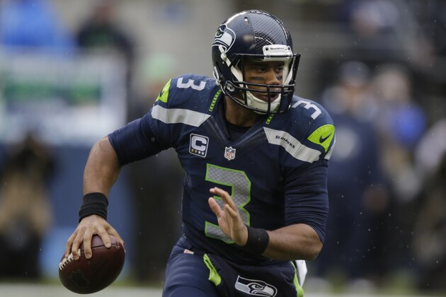 Seattle Seahawks quarterback Russell Wilson looks to pass against the Oakland Raiders in the first half of an NFL football game, Sunday, Nov. 2, 2014, in Seattle. (AP Photo/Stephen Brashear)