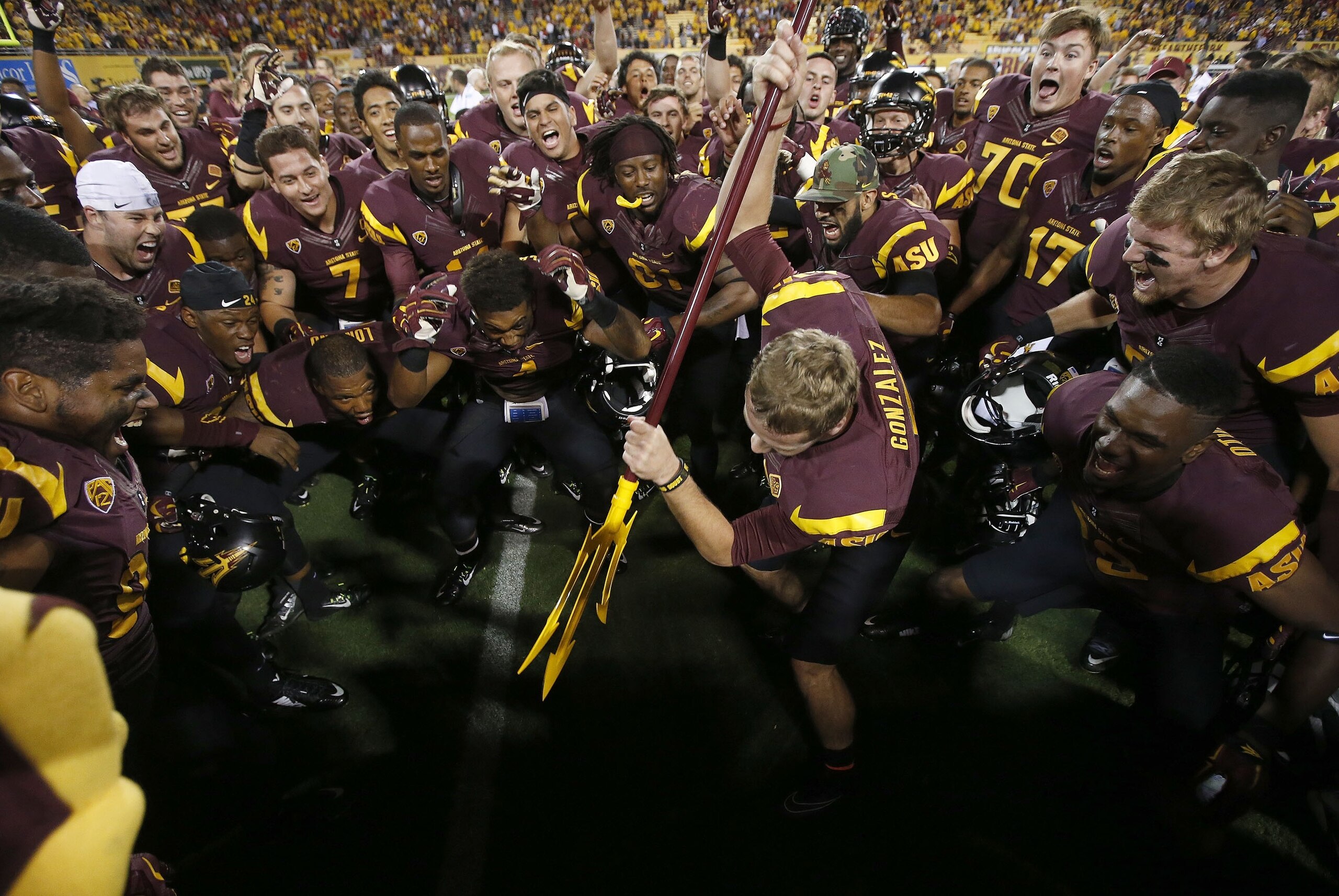 Arizona State's Zane Gonzalez gets ready to send a pitchfork into the ground as his teammates cheer him on, after his kicked a game-winning field goal against Utah, after an NCAA college football game on Saturday, Nov. 1, 2014, in Tempe, Ariz.  Arizona State defeated the Utah 19-16 in overtime. (AP Photo/Ross D. Franklin)