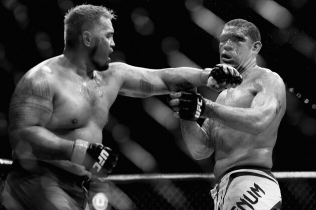 BRISBANE, AUSTRALIA - DECEMBER 07:  (This digital image has been converted to black & white) Mark Hunt punches Antonio 'Bigfoot' Silva in their heavyweight fight during the UFC Fight Night event at the Brisbane Entertainment Centre on December 7, 2013 in Brisbane, Australia.  (Photo by Chris Hyde/Getty Images)