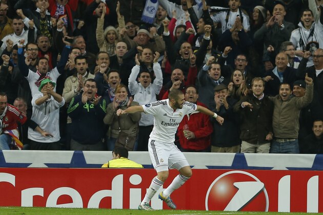 Real Madrid's Karim Benzema celebrates his goal with fans during a Group B Champions League soccer match between Real Madrid and Liverpool at the Santiago Bernabeu stadium in Madrid, Spain, Tuesday Nov. 4, 2014. (AP Photo/Paul White)