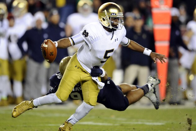 Notre Dame quarterback Everett Golson (5) spins away from Navy defensive end Will Anthony (90) during the first half an NCAA college football game Saturday, Nov. 1, 2014, in Landover, Md. (AP Photo/Nick Wass)