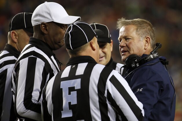 Notre Dame coach Brian Kelly, right, talks with officials during the first half an NCAA college football game against Navy at FedEx Field, Saturday, Nov. 1, 2014, in Landover, Md. (AP Photo/Alex Brandon)