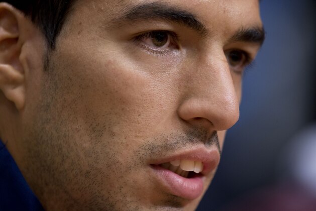 Barcelona's Luis Suarez listen to questions during a press conference at ArenA stadium in Amsterdam, Netherlands, Tuesday, Nov. 4, 2014, one day ahead of the Group F Champions League match between AFC Ajax and FC Barcelona. Suarez will be playing his first Champions League game for Barcelona following suspension for biting Italy defender Giorgio Chiellini at the World Cup. Suarez played for Ajax from 2007 to 2011. He was club captain and player of the year. (AP Photo/Peter Dejong)
