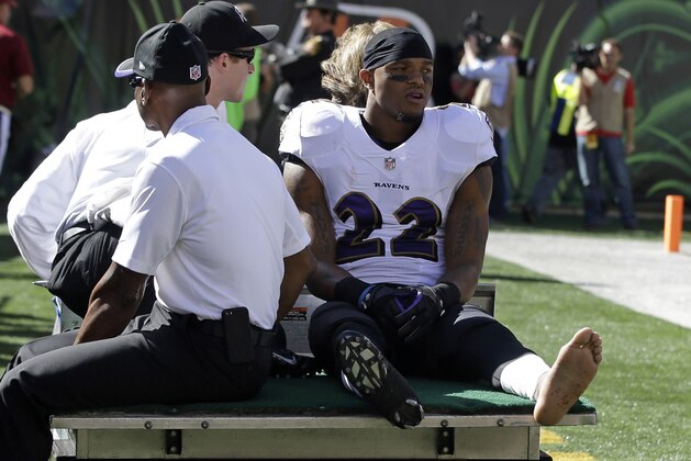 Baltimore Ravens cornerback Jimmy Smith (22) is taken off the field after being injured during the first half of an NFL football game against the Cincinnati Bengals in Cincinnati, Sunday, Oct. 26, 2014. (AP Photo/Darron Cummings)